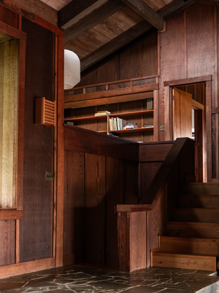 the redwood staircase leads to a lofted space and bedrooms. 26