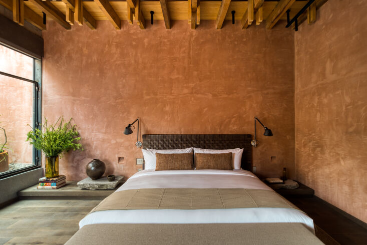 bedrooms have lofty ceilings with exposed wooden joists. 20