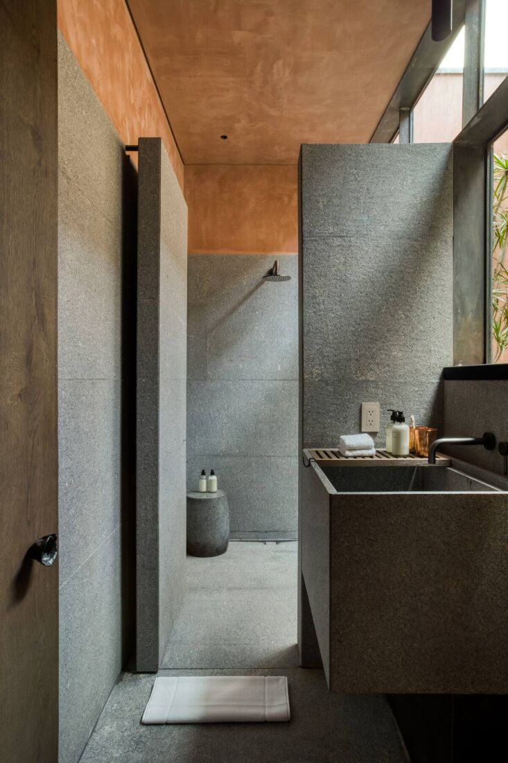 one of several bathrooms has an indoor rain shower and a sink with a view. 23