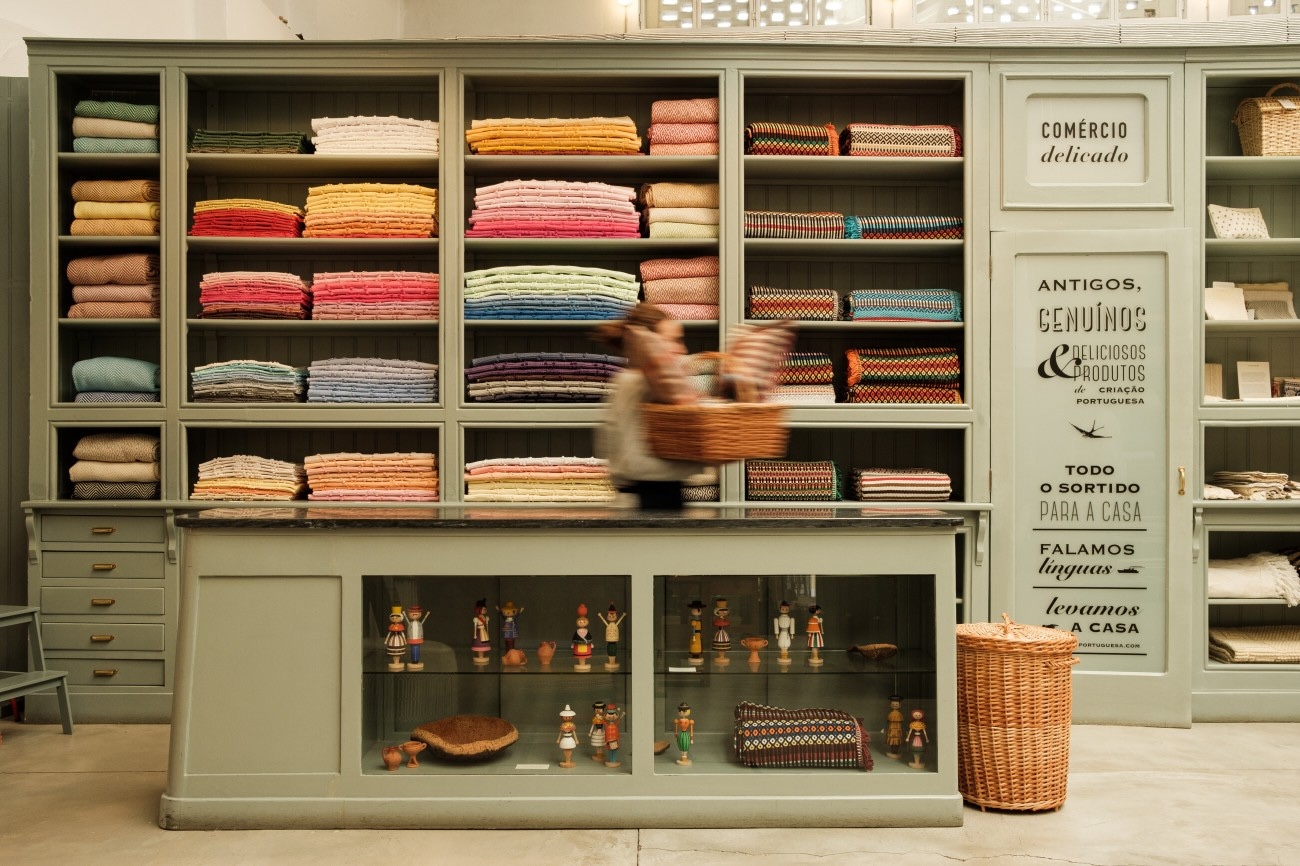 a general store style display of herringbone scarves, cotton throws, and multi 19
