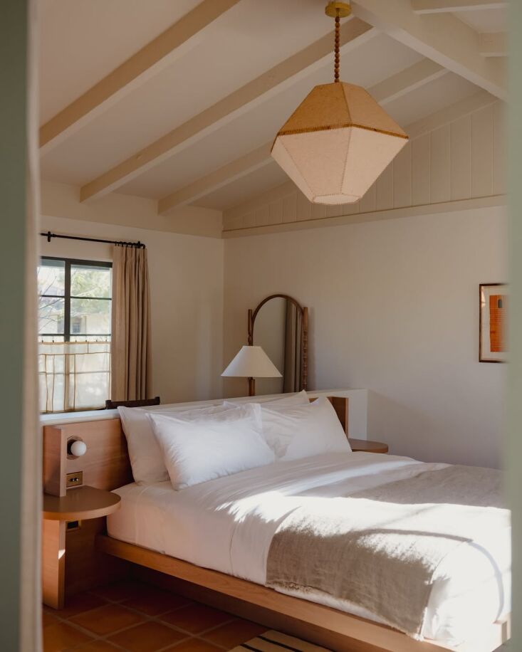 a commissioned lamp by lana launay hangs in this guest bedroom. \2\20;wh 24