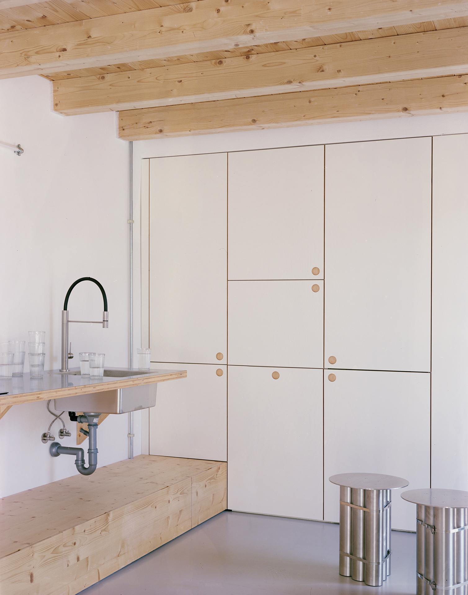 the kitchen has a counter of fir topped with stainless steel and inset with a s 20