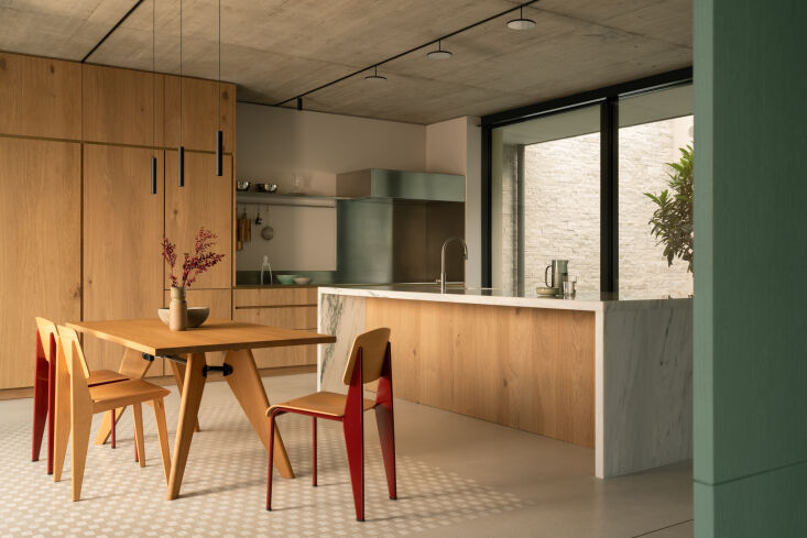 the kitchen island has a wrap around frame of solid marble—the project 20