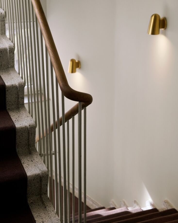 the original handcrafted banister and terrazzo stair. the stairwell is lit with 31