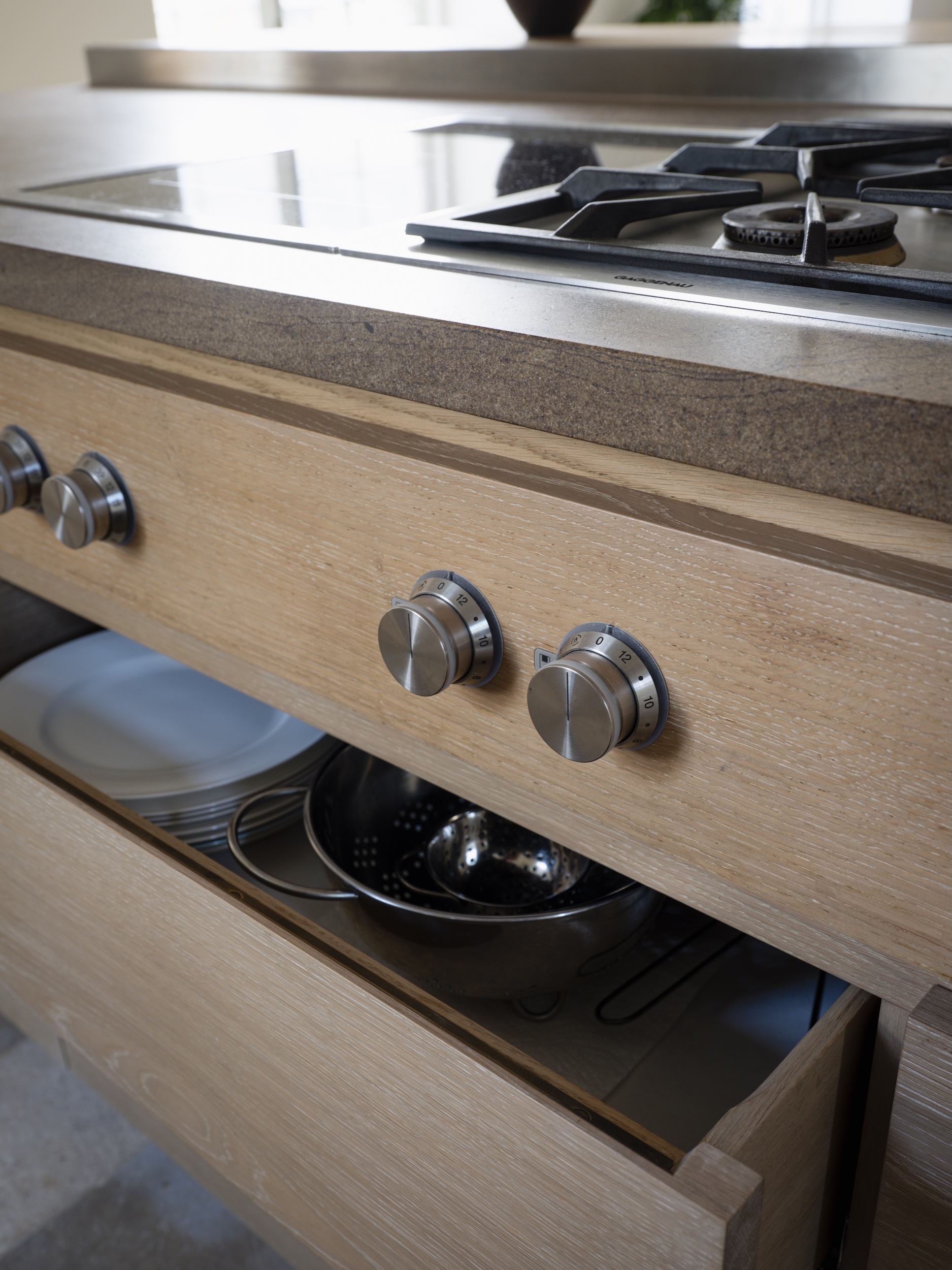useful storage beneath the gaggenau cooktop. 22