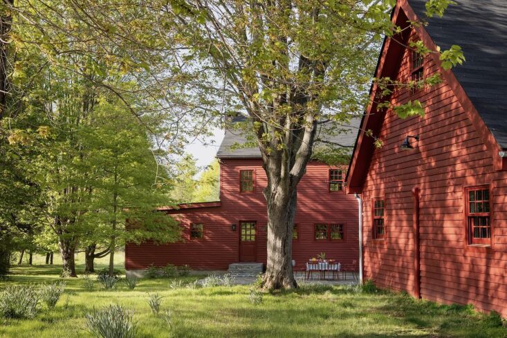 the back terrace overlooks an outbuilding that the couple use as a cottage. ama 32