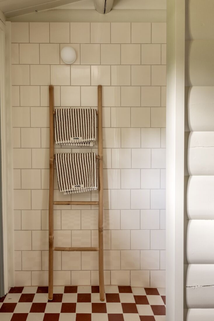 tekla towels hang on a wooden ladder in the bathroom. 28