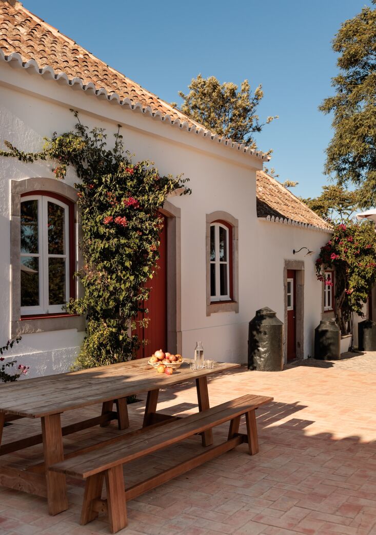 outdoor dining alongside vintage black metal olive oil containers. 28