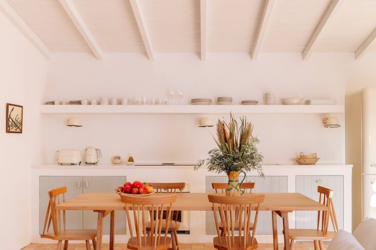 we love the two toned kitchen cabinets. the signal sconces are by remodelista f 25
