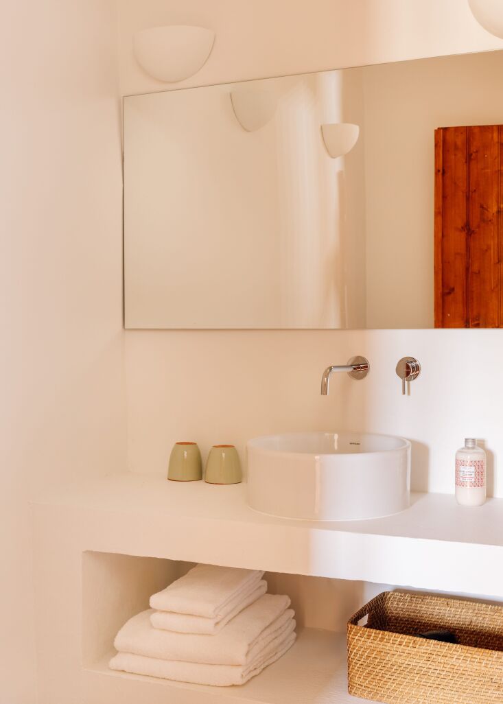 the bathrooms are clean lined and have inset storage. 27