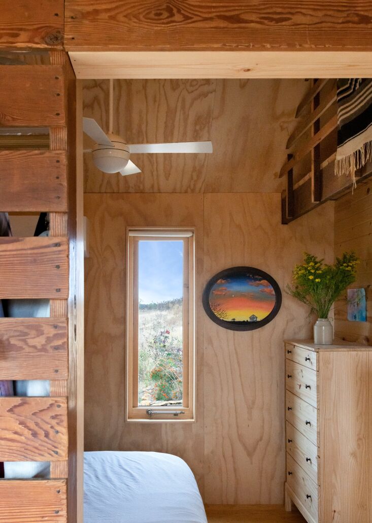 a peek into the sole bedroom, just across from the sectional in the living area 24