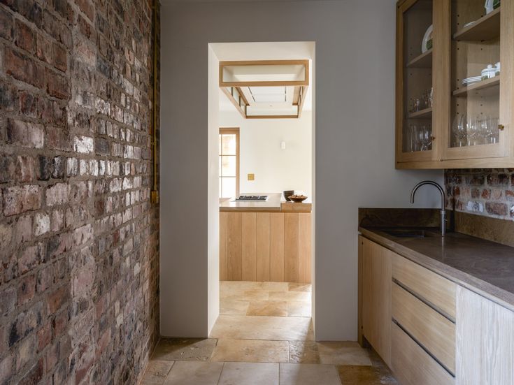the back kitchen or butler&#8\2\17;s pantry has a wall of reclaimed brick.  23