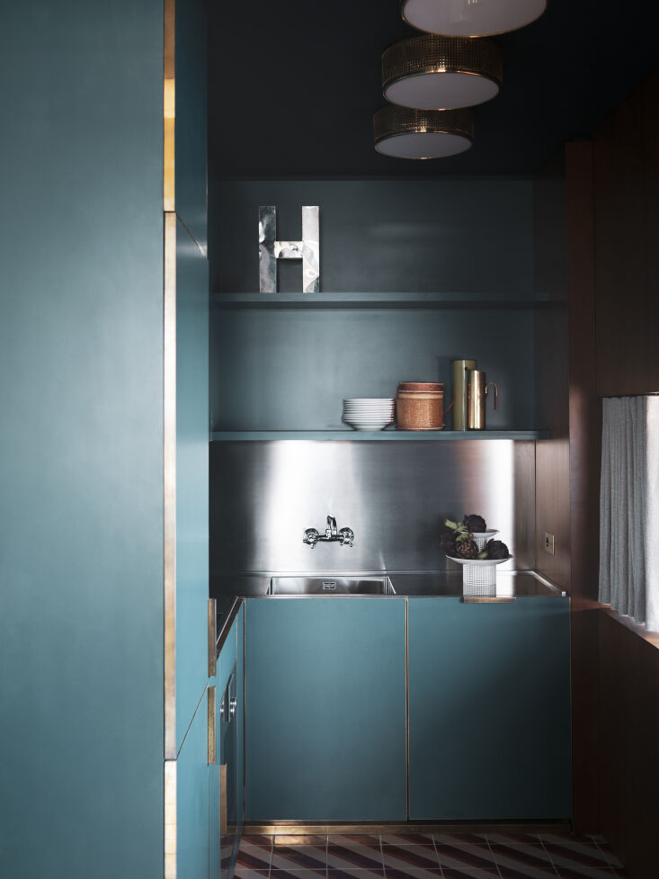 a pint sized kitchen is designed in luxe metal edged teal cabinetry. on the sta 25