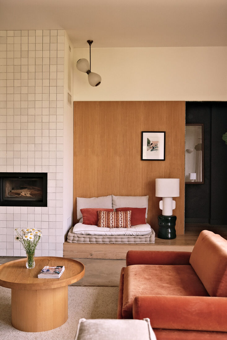in the living area, a mix of white matte tiles, wood clad walls, and warm hues. 19
