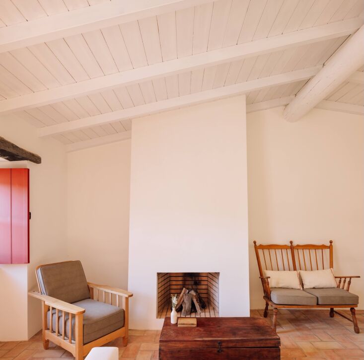 off the entry, an old style armchair designed by the architects stands by a wor 24