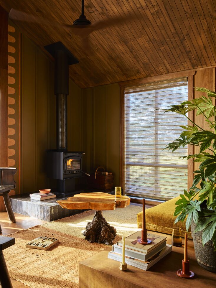 a barn living room with custom daybed and vintage live edge burled root table. 21