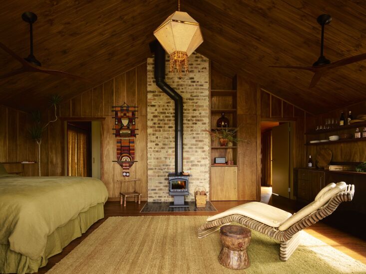 a suite with a wood burning stove, lana launay stitched paper light, and in roo 27