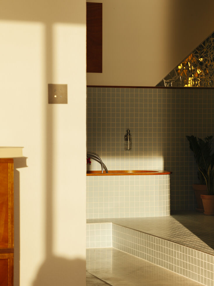 a step up tiled tub. photograph by edouard sanville. 26