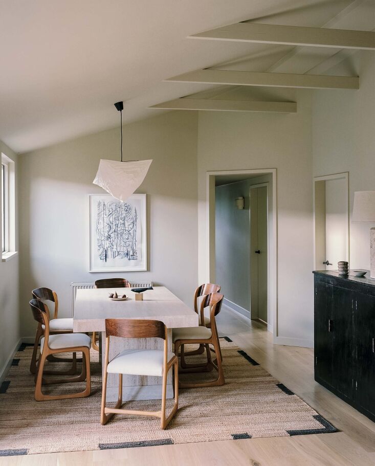 the dining room features vintage upholstered baumann sleigh chairs, the nordic 25