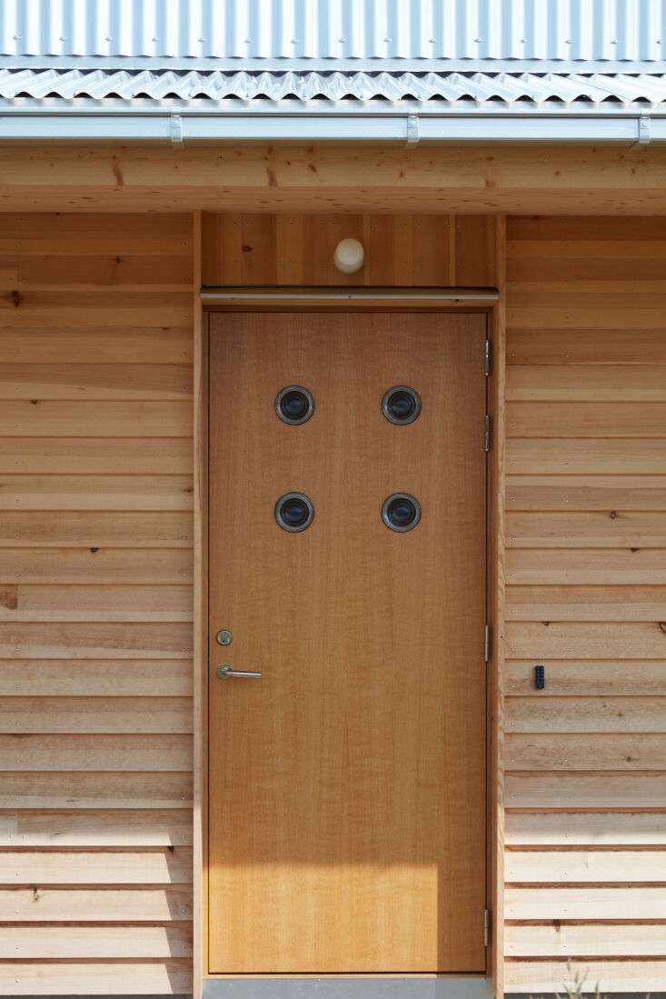 a uniquely designed front door, complete with four small porthole windows. 18