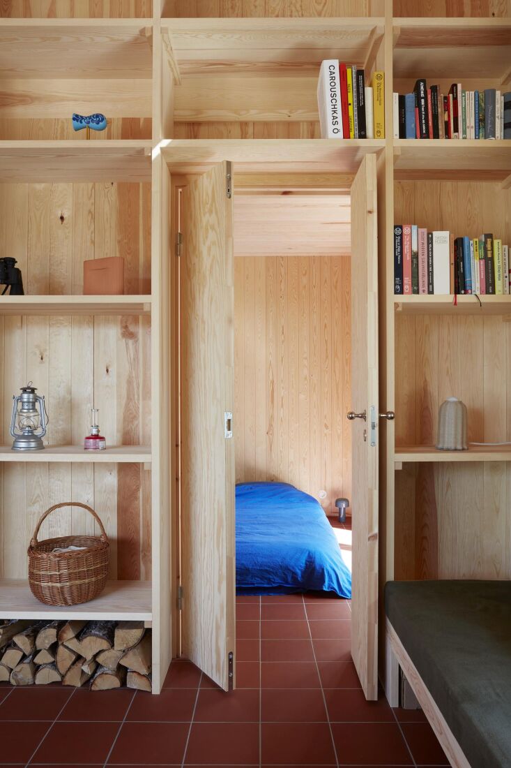 a view into the cabin&#8\2\17;s one bedroom, complete with bright blue bedd 23