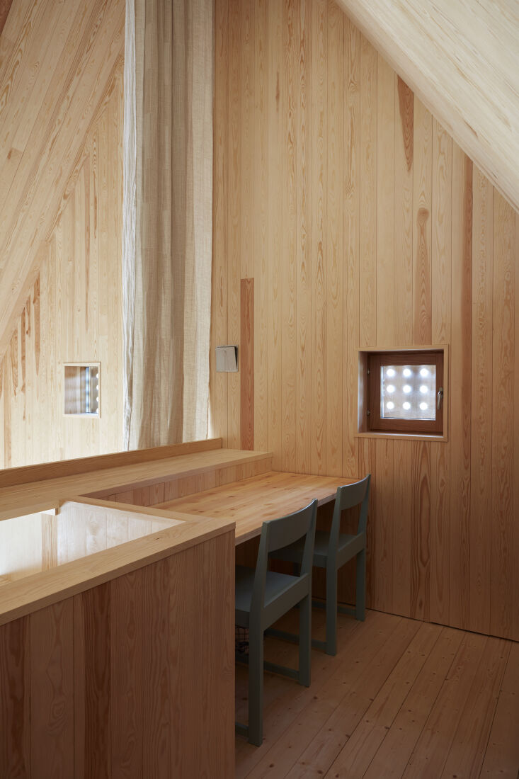 the loft is designed as a pared back work space with a curtain. 25