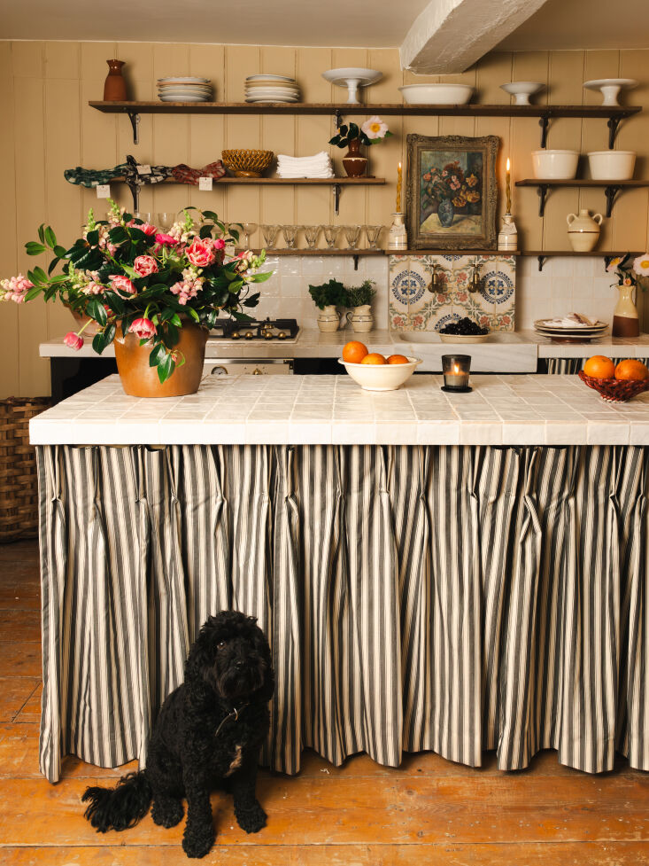 the large center island, which is ideal for prep work, is wrapped in a cream an 20