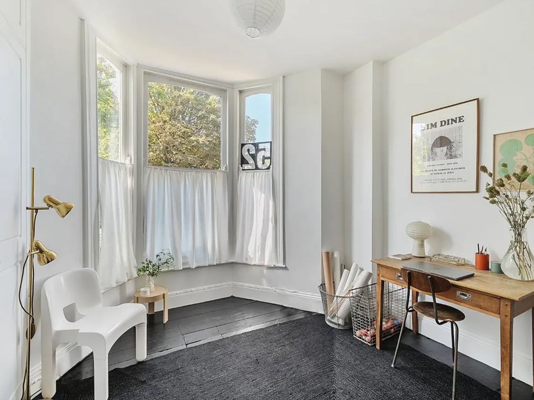sandy uses the front bedroom as her office. she hand stitched the curtains from 32