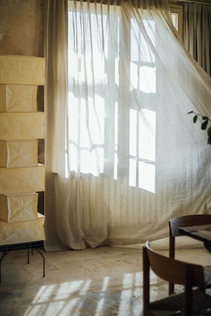 the standing paper lamp is via vitra, and the linen curtains are from by mölle. 24