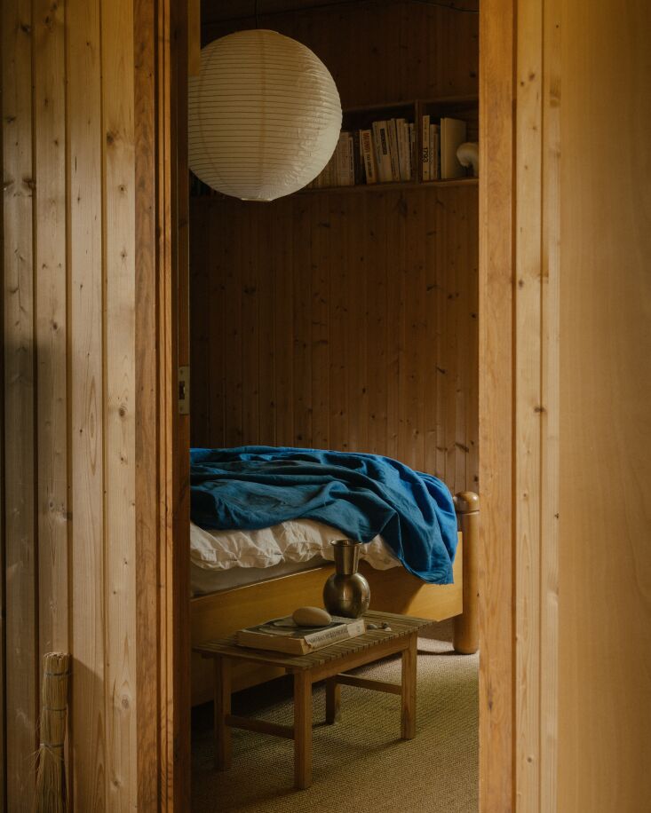 an original pocket door opens into the main bedroom, complete with wall mounted 25