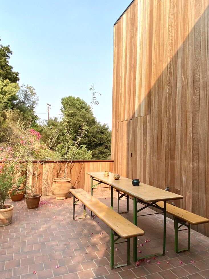 a vintage german biergarten table on the deck and a nearly invisible door that 30