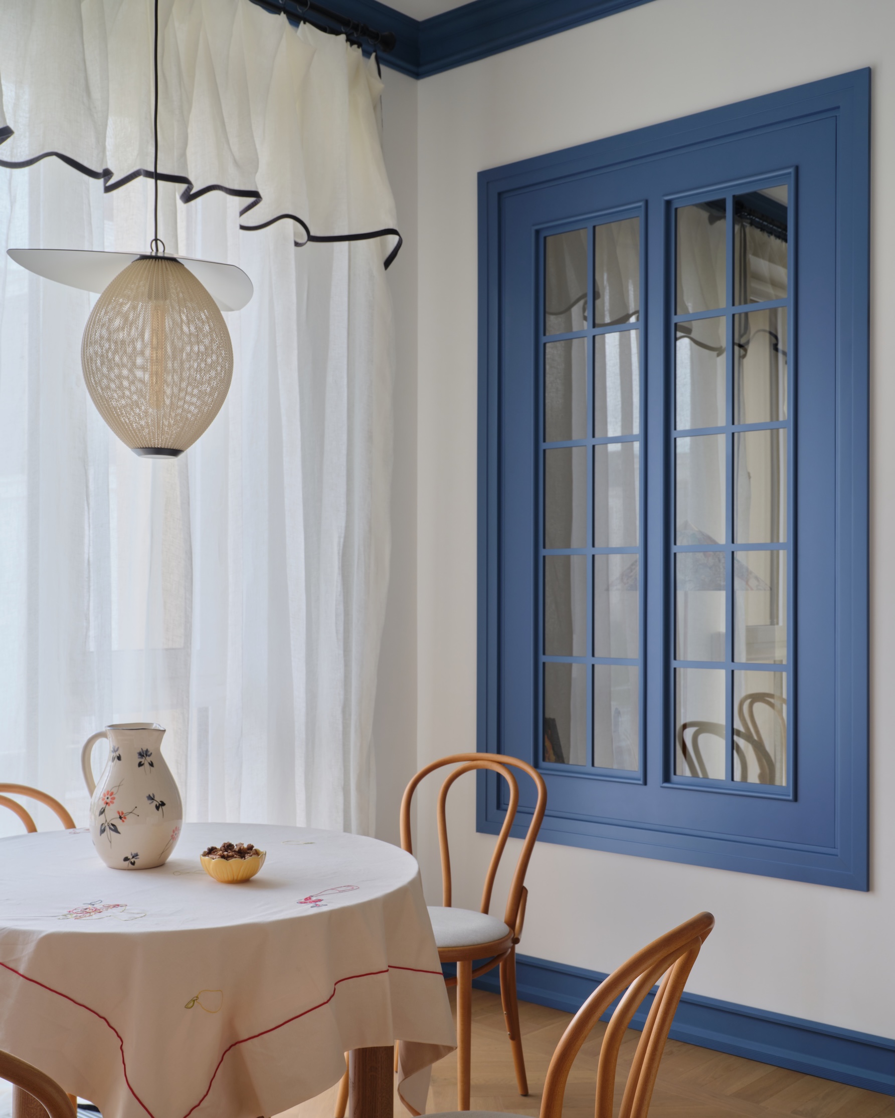 thonet hairpin bentwood chairs surround the table. the hanging light is gubi&am 24