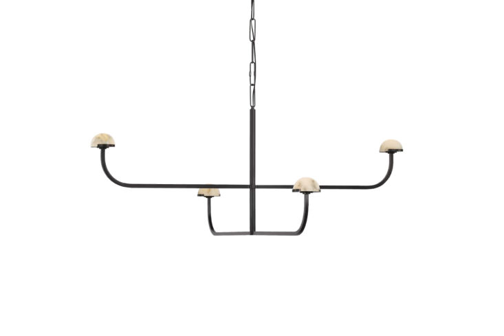 the kelly wearstler pedra two tier shallow chandelier hangs above the bed; \$3, 29