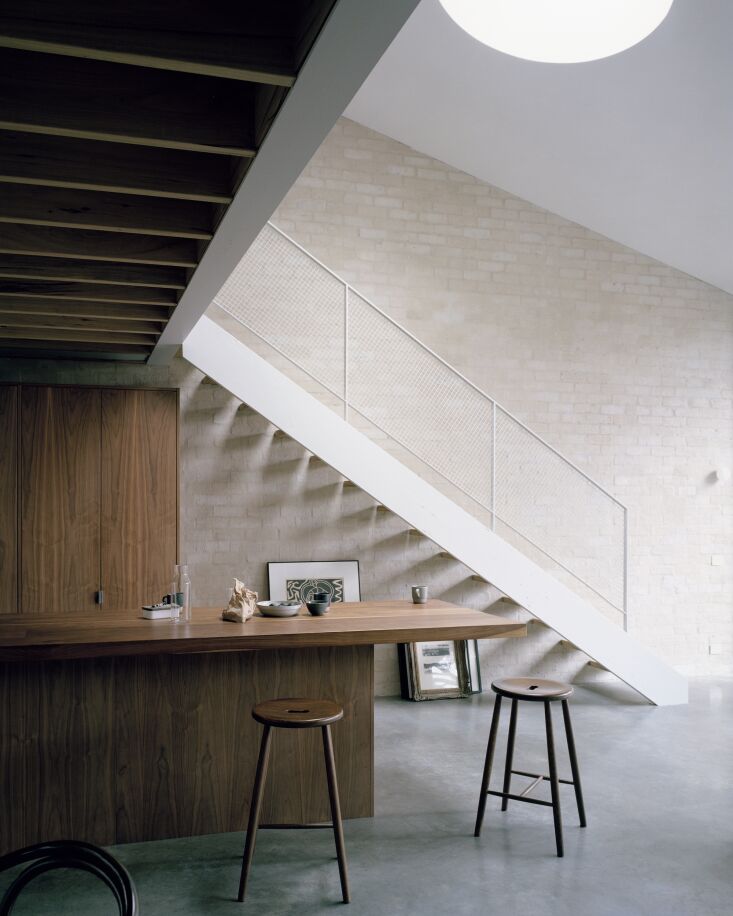 the kitchen island and cabinets, tucked under the loft, are made from american 27