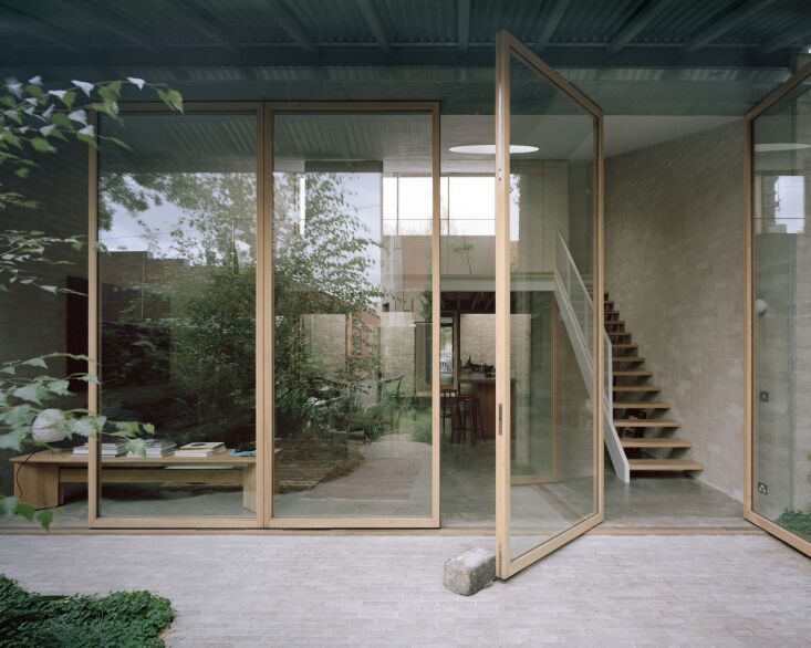 a series of \10.5 foot tall pivot glass doors in the new extension blurs the li 19