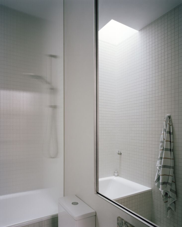 the loft also includes a bathroom. note the shower screen with fluted glass, a 30
