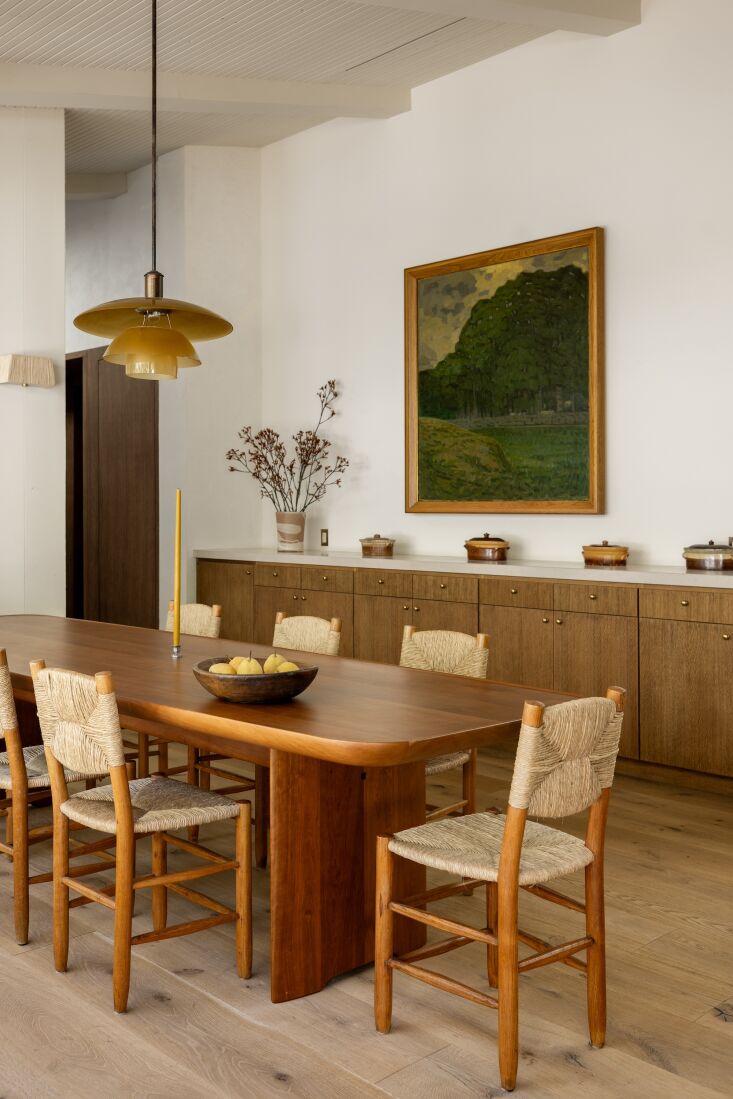 a built in oak console in the dining room mimics the kitchen cabinetry; the kno 20
