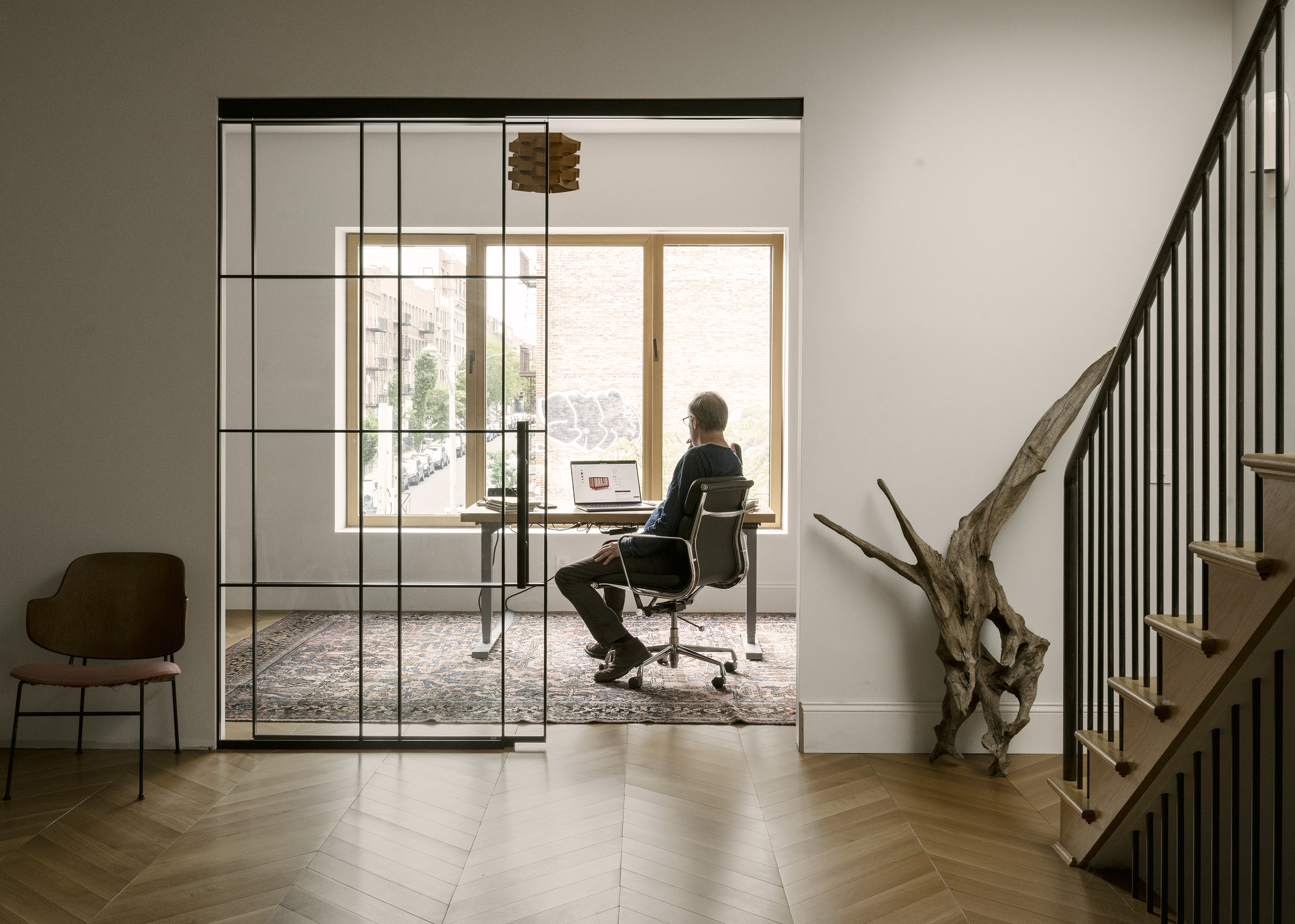 a vintage penguin chair and giant piece of driftwood stand outside michael& 23