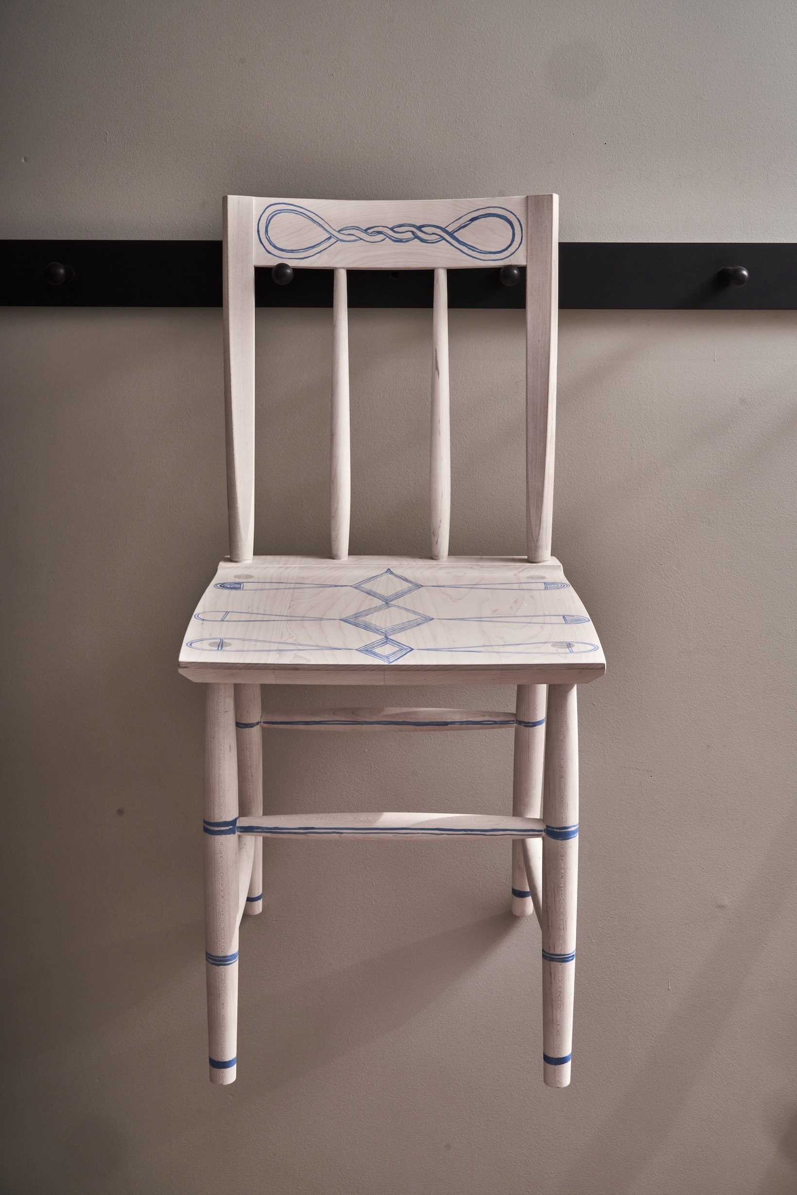 the penn chair, in bleached maple painted with india ink, hangs on the dining r 22