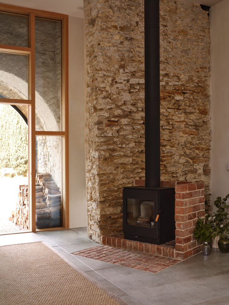 the room has a burley wood burning stove set into an exposed old stone wall. ph 29