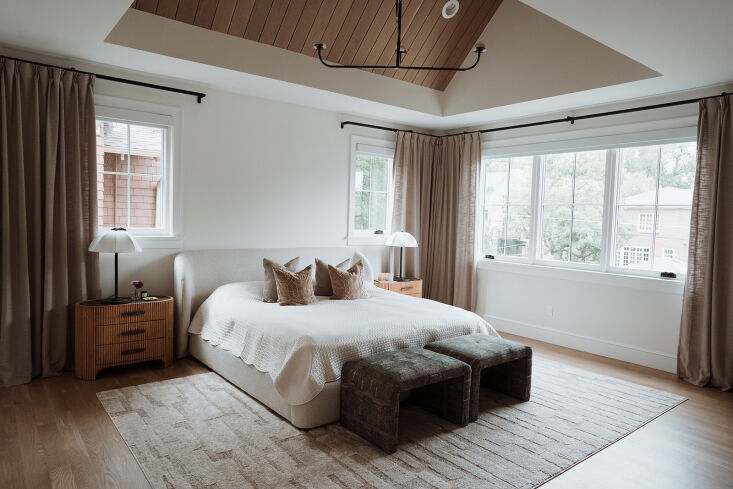 the bedroom is anchored with warm wood and a neutral palette. photograph by lin 18