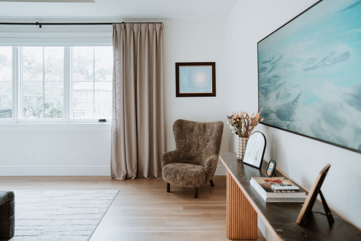 on the other side of the bedroom are a marble topped console table and a danish 21