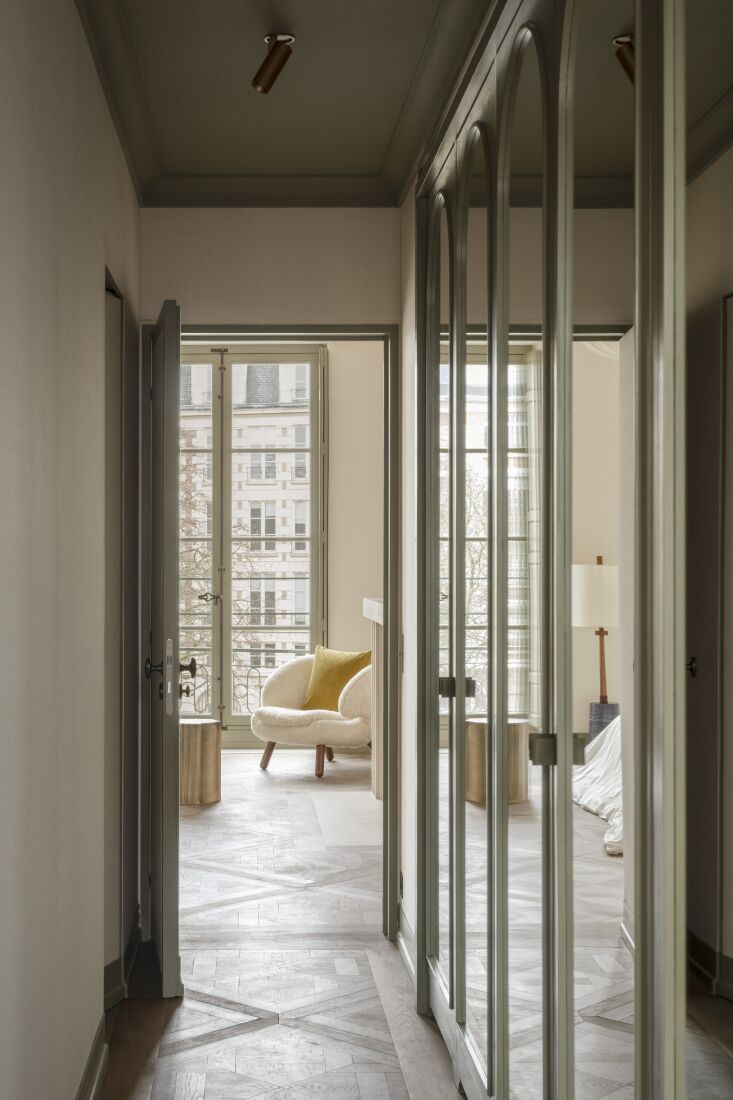 a view from the hallway into the main bedroom highlights the finn juhl pelican  18