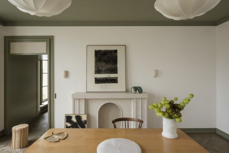 the dining room features another beige fine stone mantel and custom sconces. th 24
