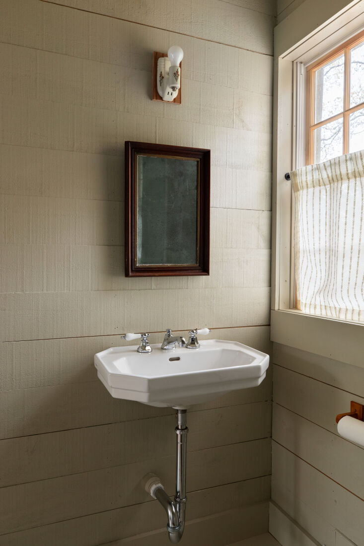 the bath is kept simple, with antique mirror and hot water, though the cottage 23