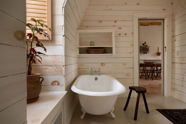 the bath features a clawfoot tub and wood cladding. \2\20;all of the woo 28