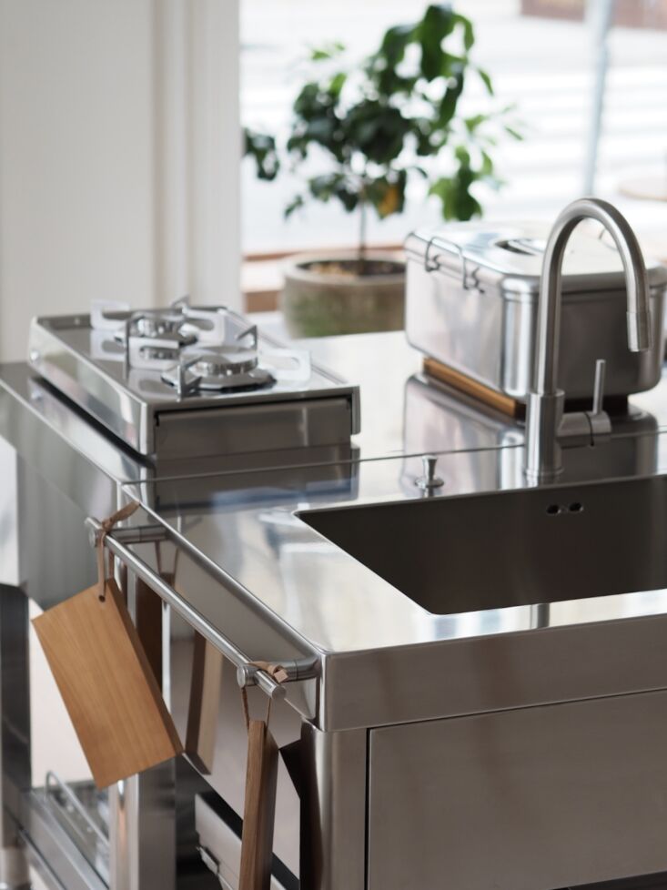 a detail of alpes inox worktables complete with gas hob and a sink. 23