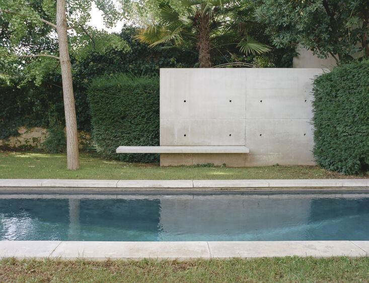 the pool was newly integrated into the backyard, with coping stones made of con 32