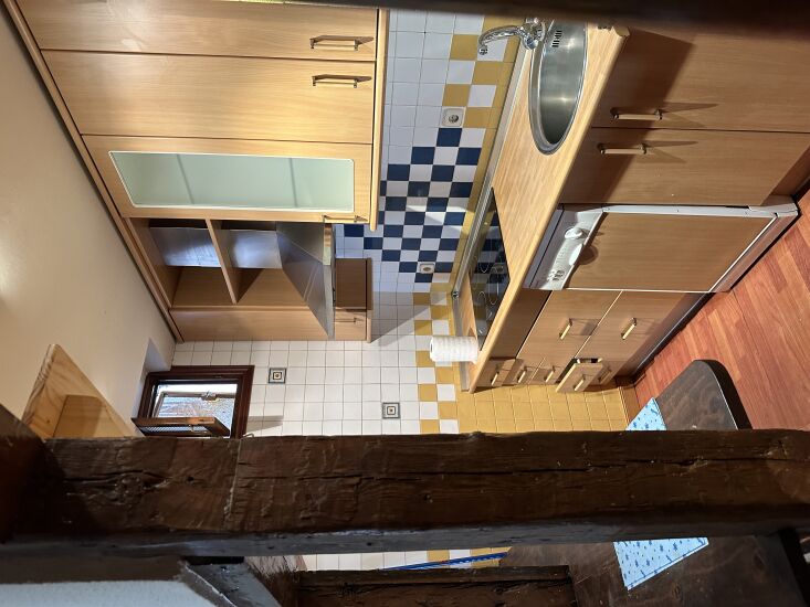 and the kitchen before: closed off, cramped, and worn. 28