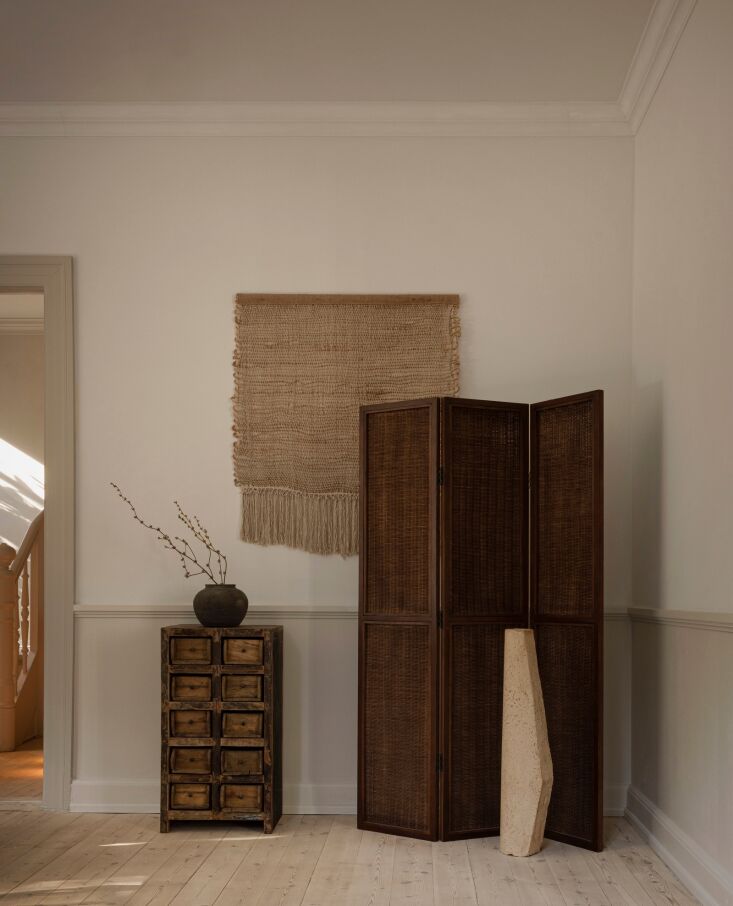 a corner of antiques and a hand knotted weaving from norm architects. 28
